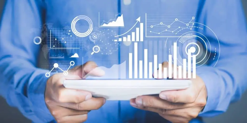 Efficient data exchange using the MQTT protocol with ZENTUP middleware and real-time analytics. Hands holding a tablet with overlaid digital charts and graphs rpresenting real-time data analytics via the MQTT protocol and ZENTUP.